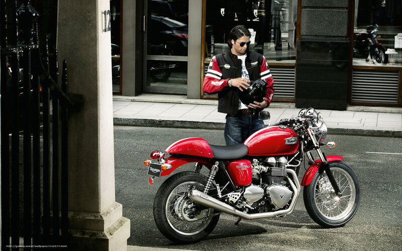 Man with red motorcycle on street