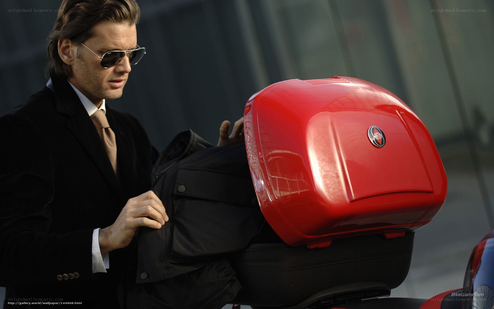 Man with red motorcycle storage