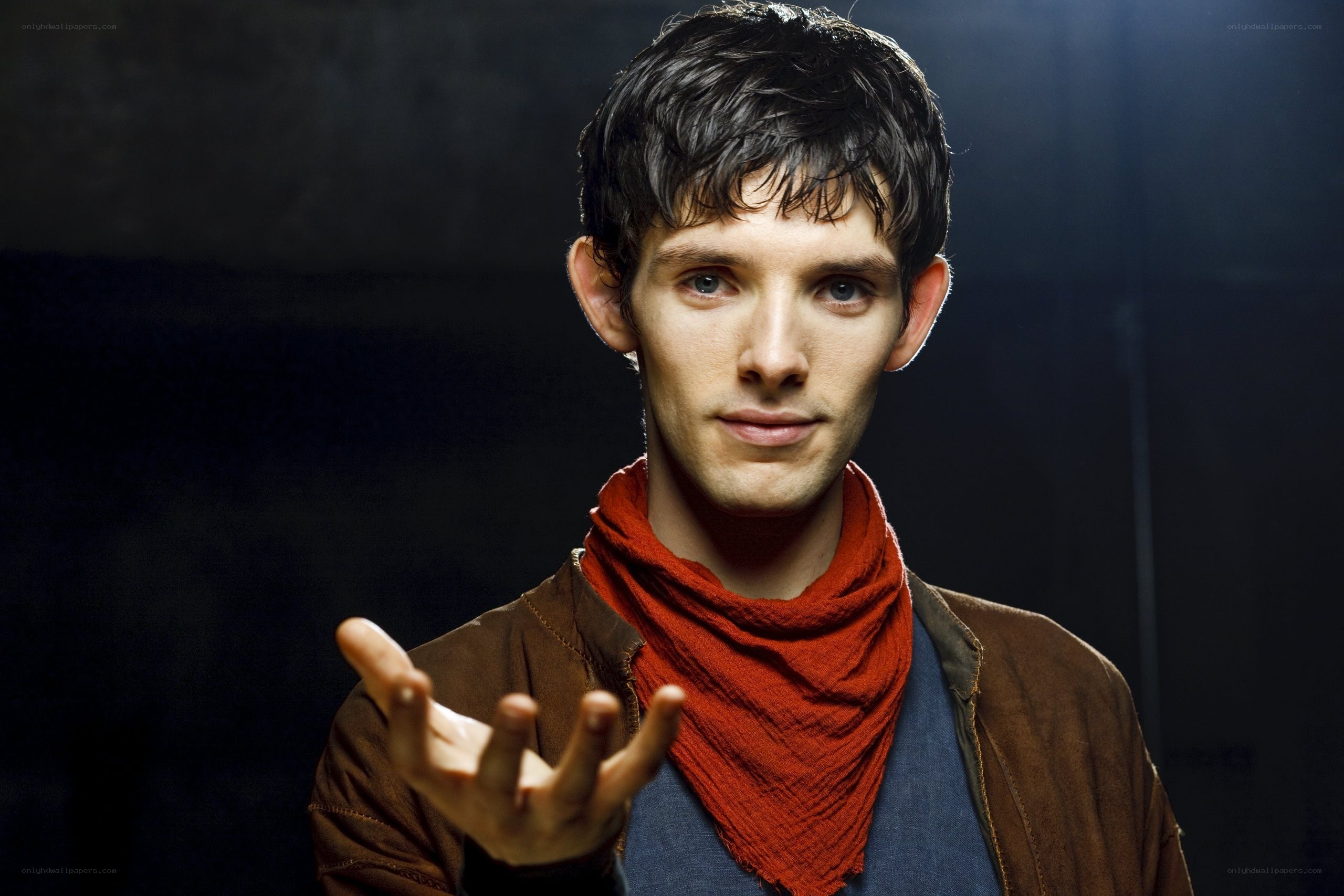 man with red scarf and brown jacket