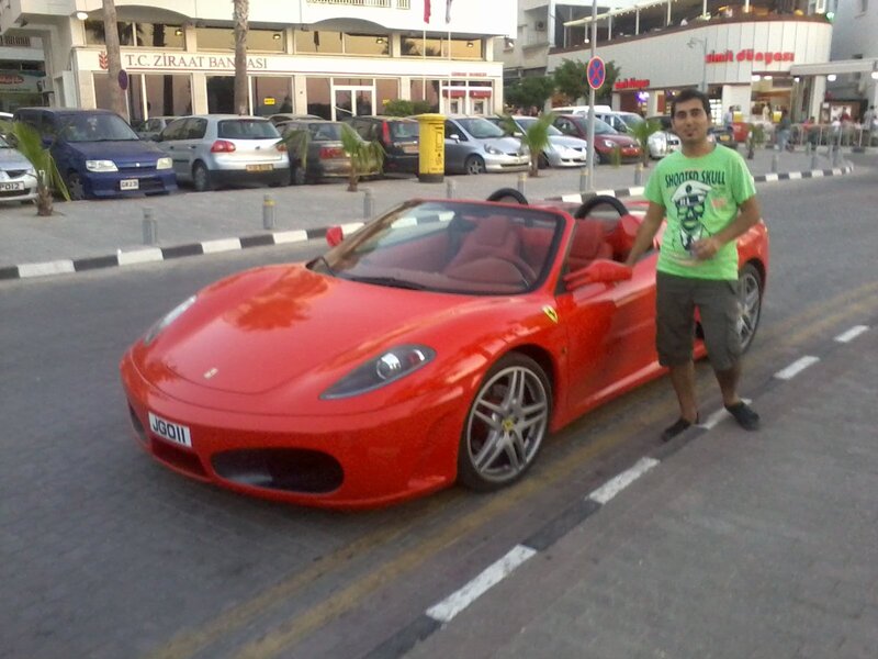 man with red sports car