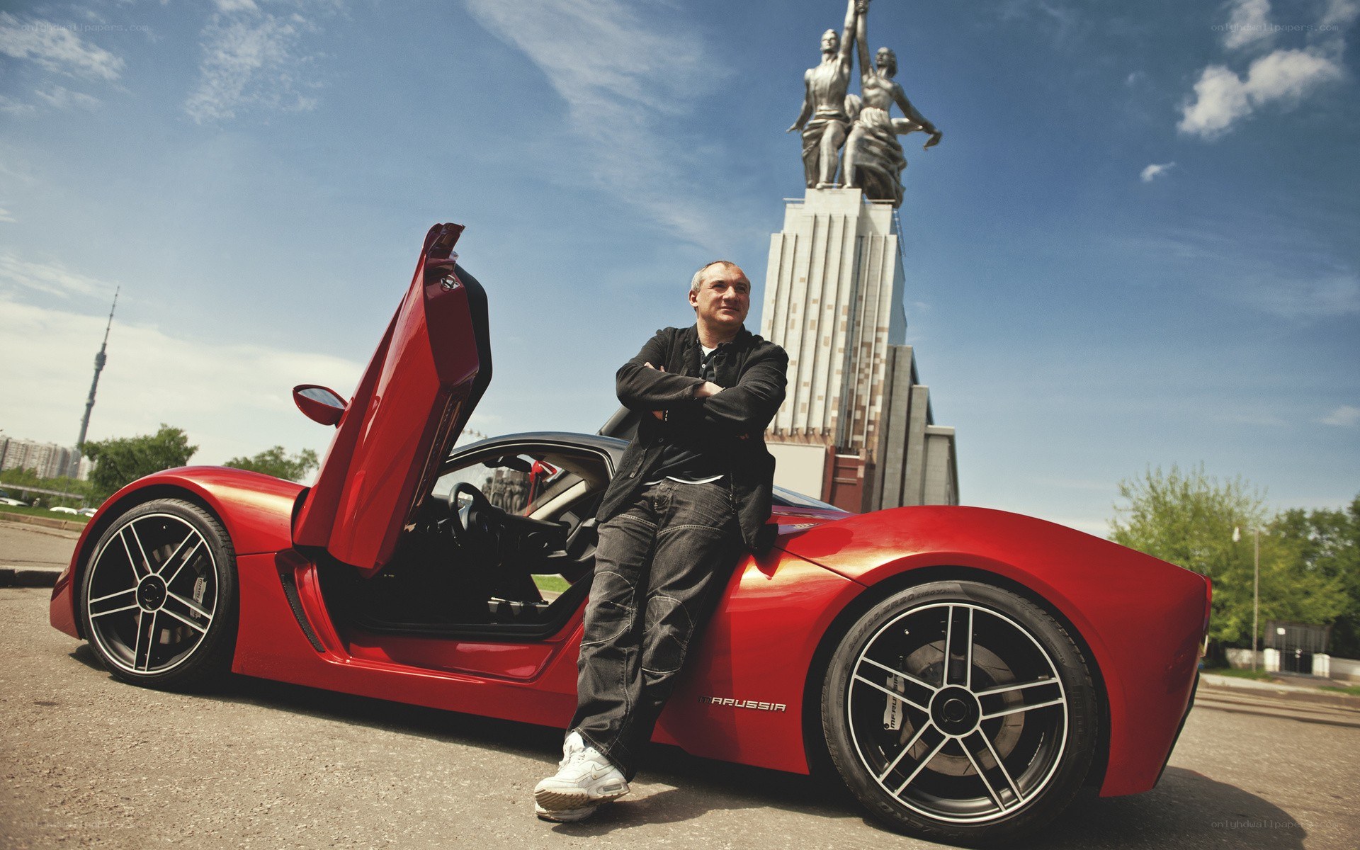 Man with red sports car