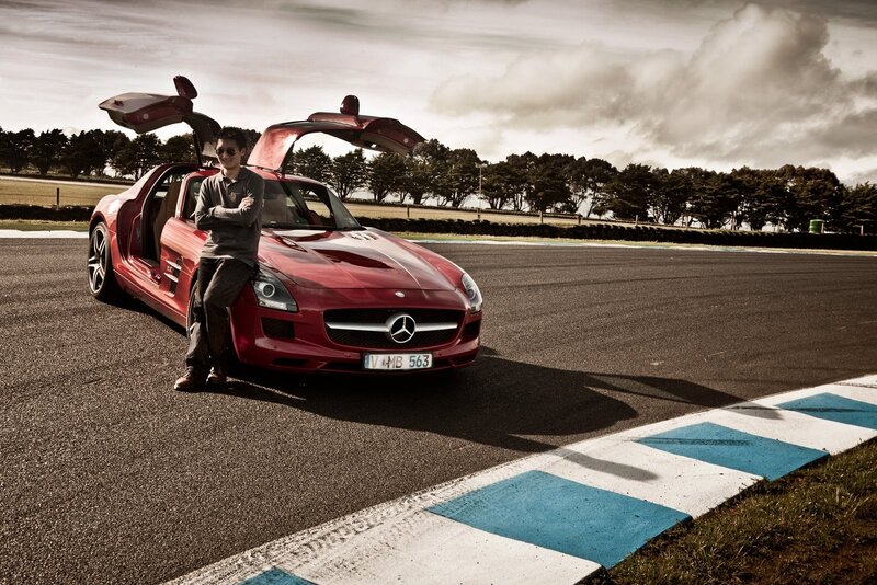 Man with red sports car on track