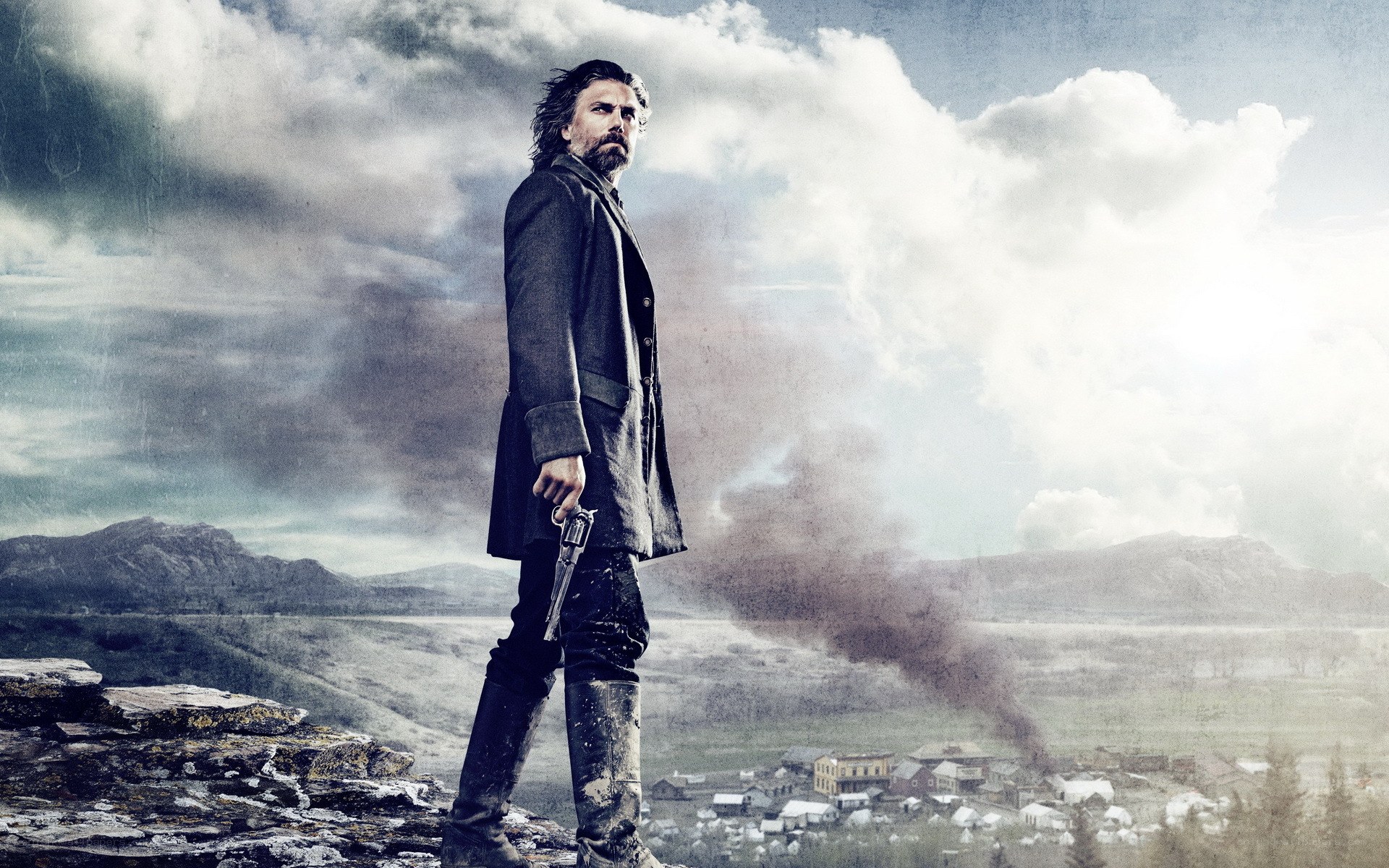 man with revolver on cliff