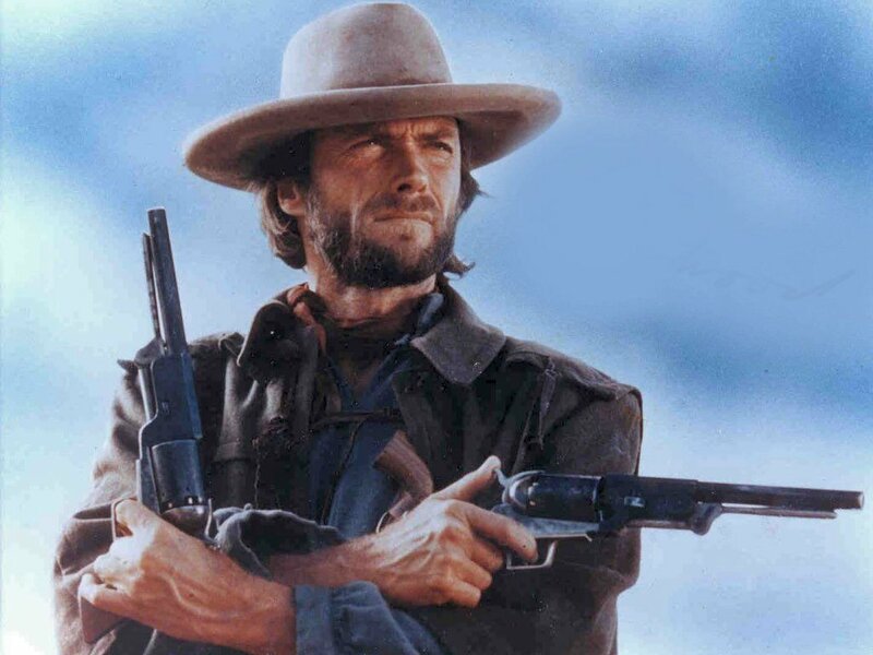 Man with revolvers in cowboy hat