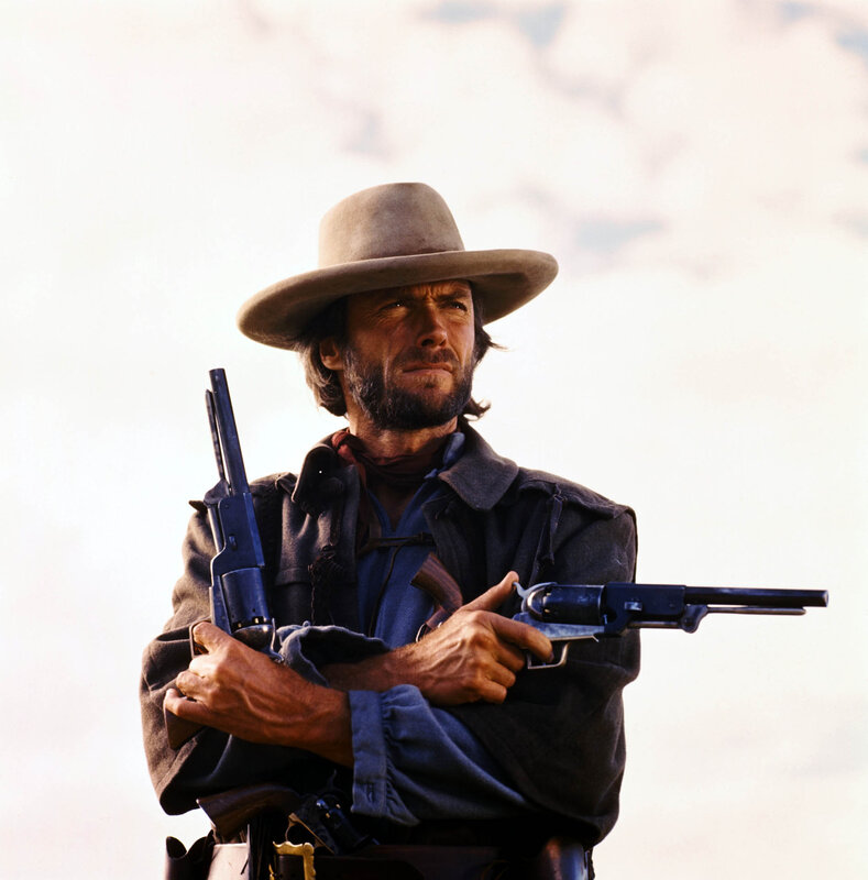 Man with revolvers in cowboy hat