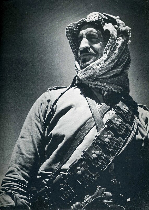 man with rifle and headscarf