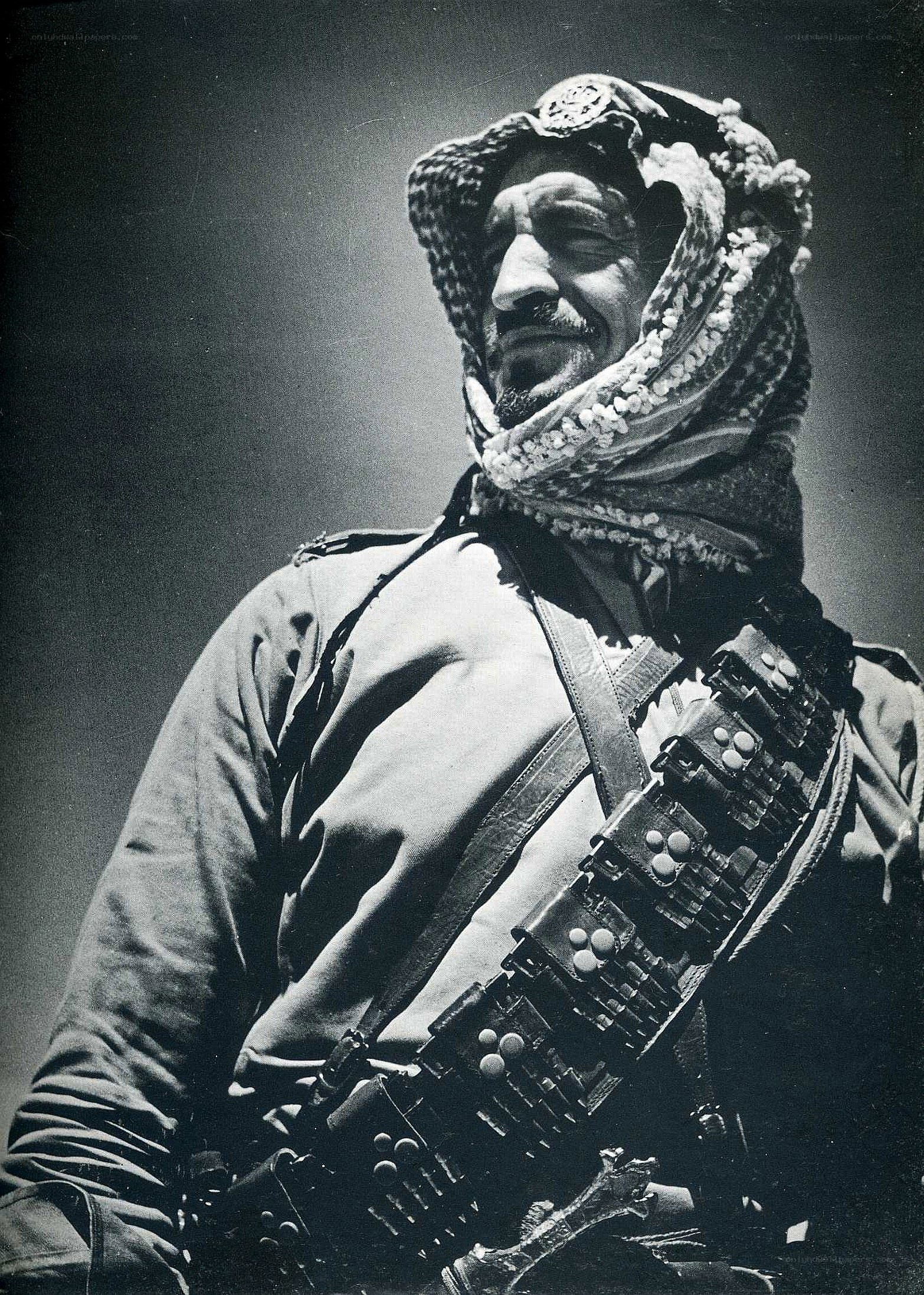 man with rifle and headscarf