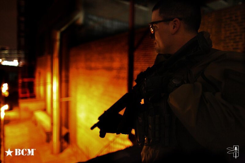 man with rifle in alley
