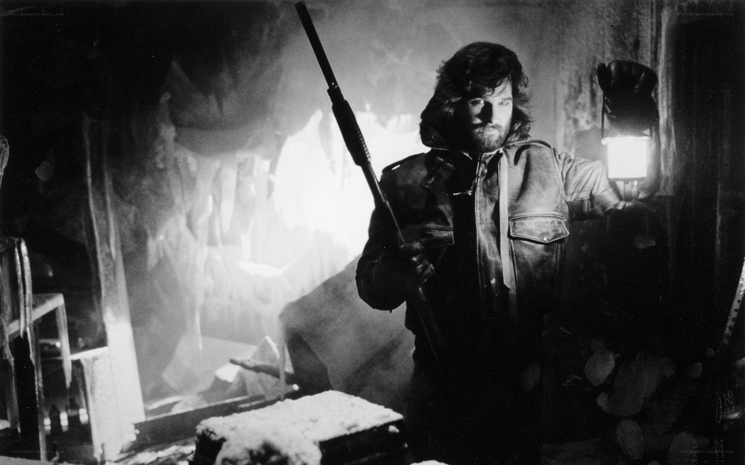 Man with rifle in dark room