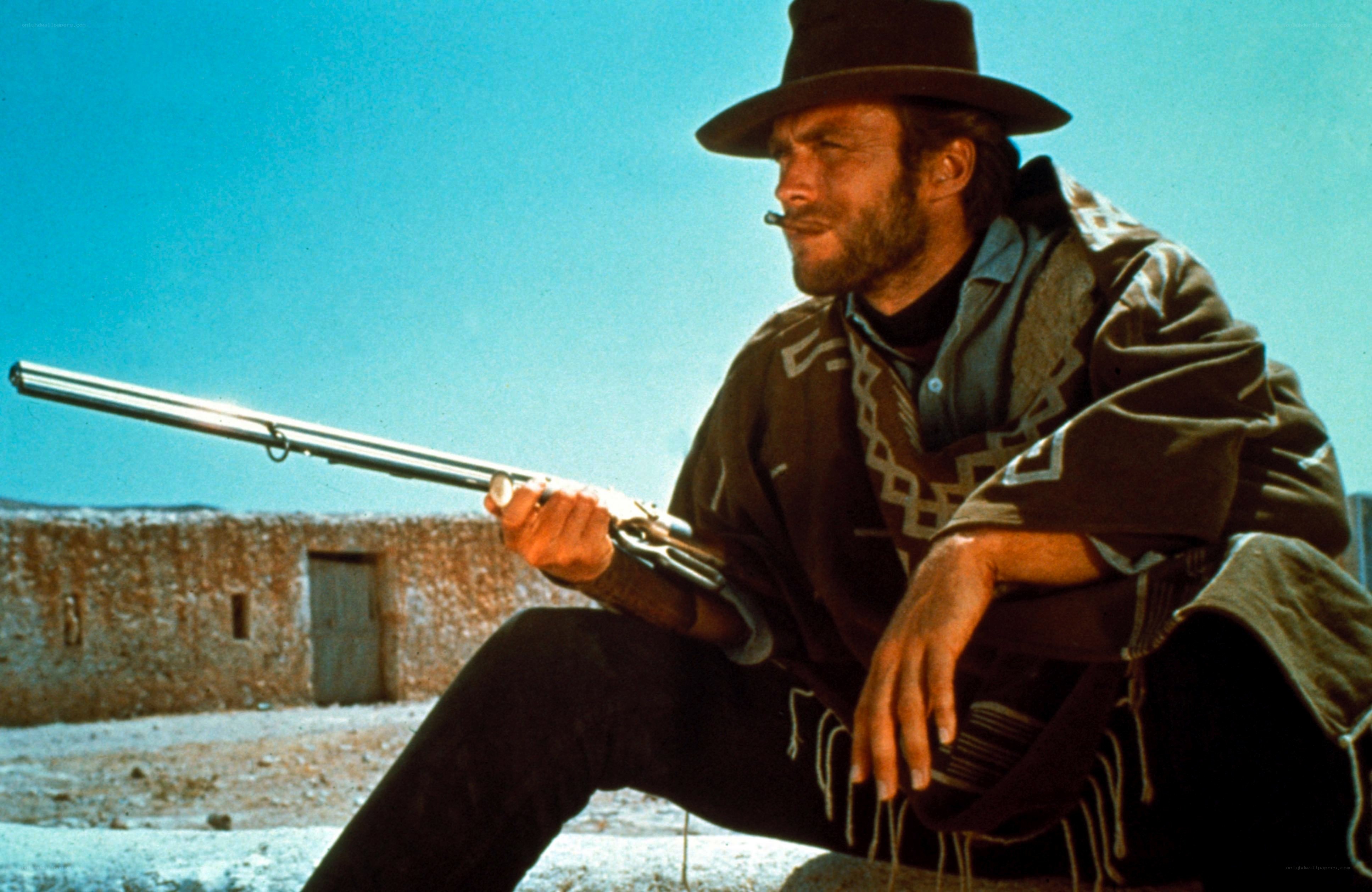 man with rifle in desert