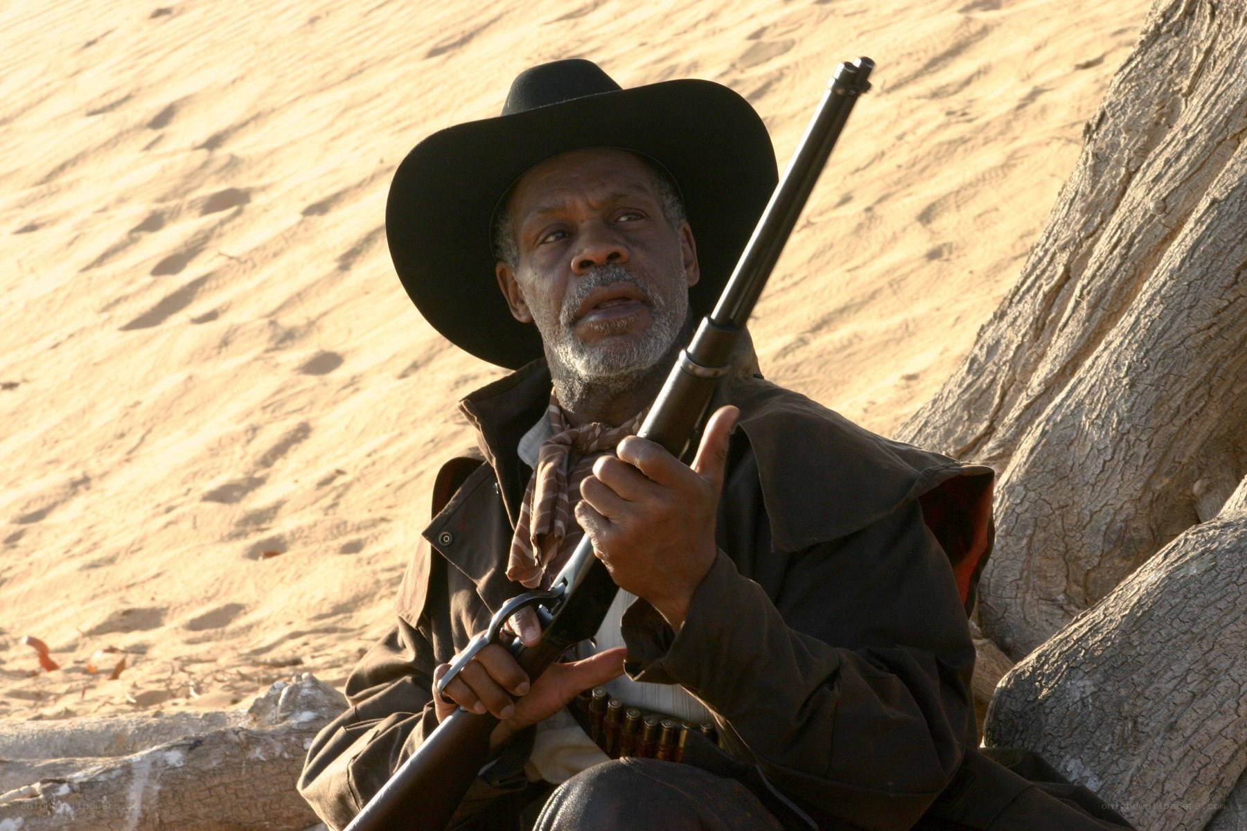 man with rifle in desert