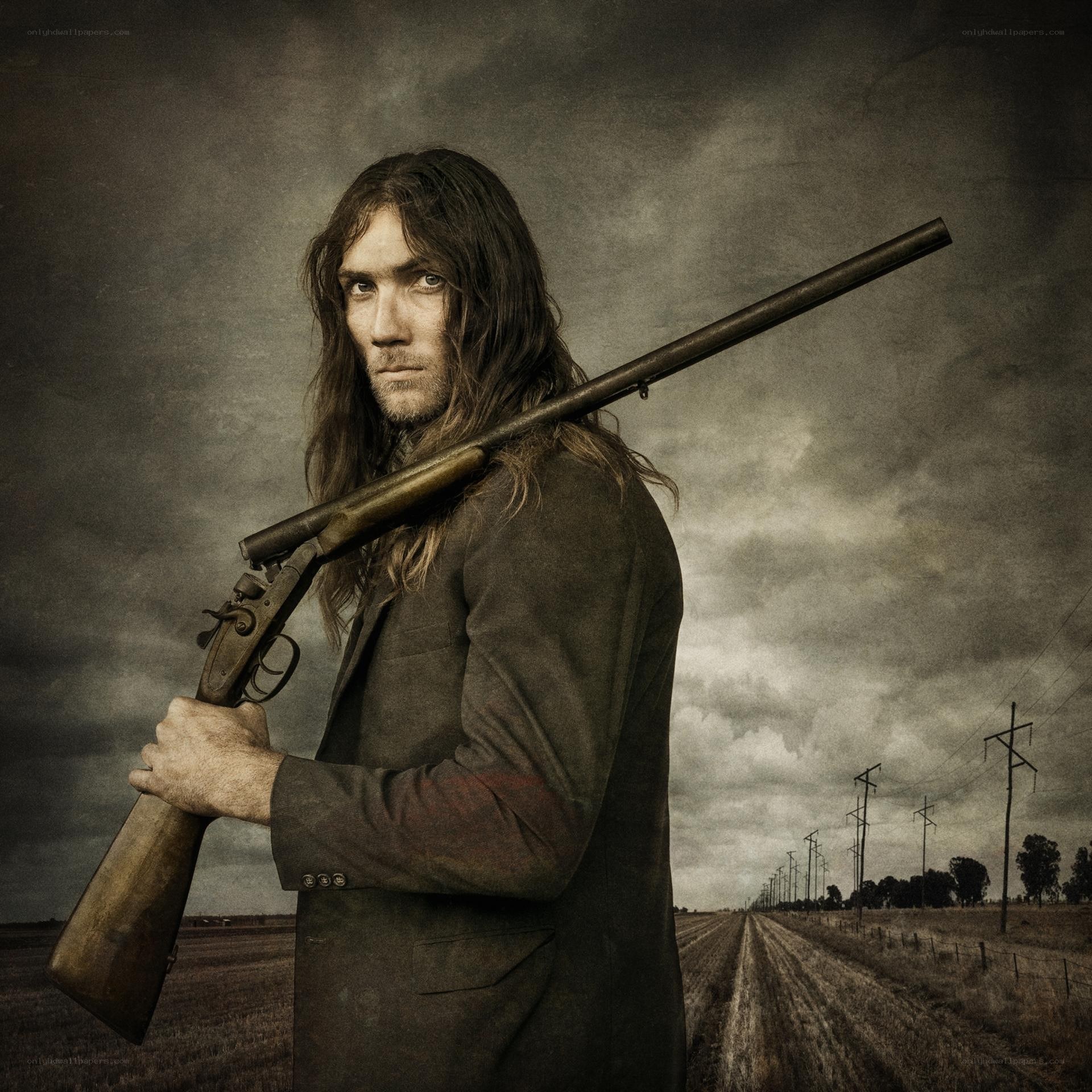man with rifle in field