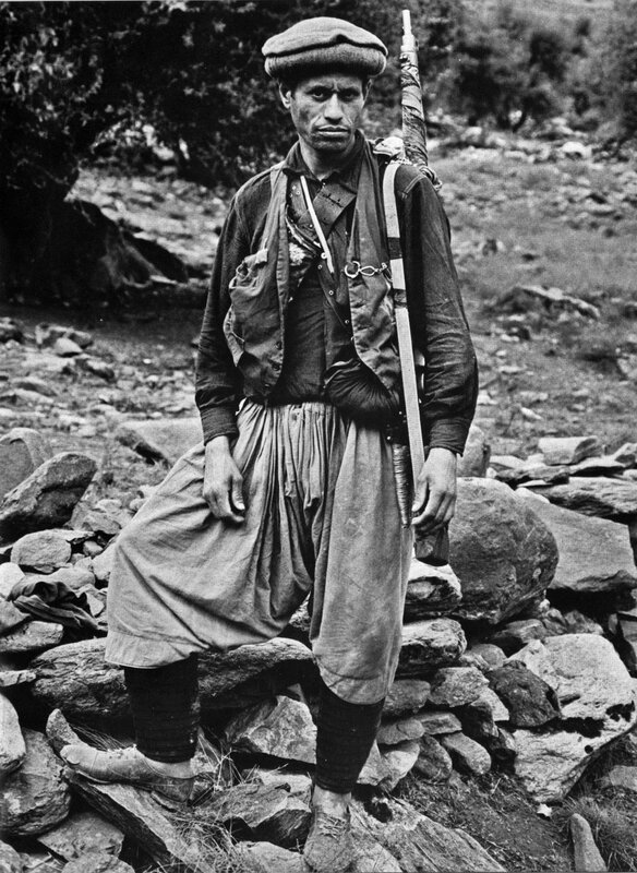 Man with rifle in mountainous terrain