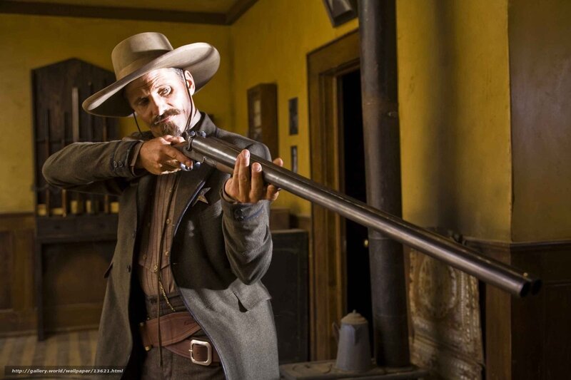 Man with rifle in old room