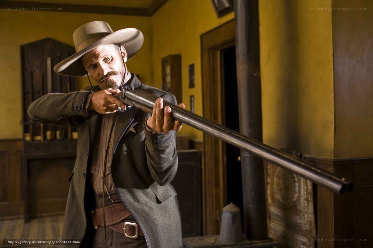 Man with rifle in old room