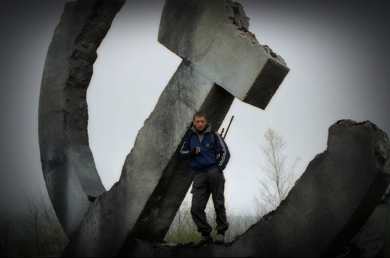 Man with Rifle Near Statue