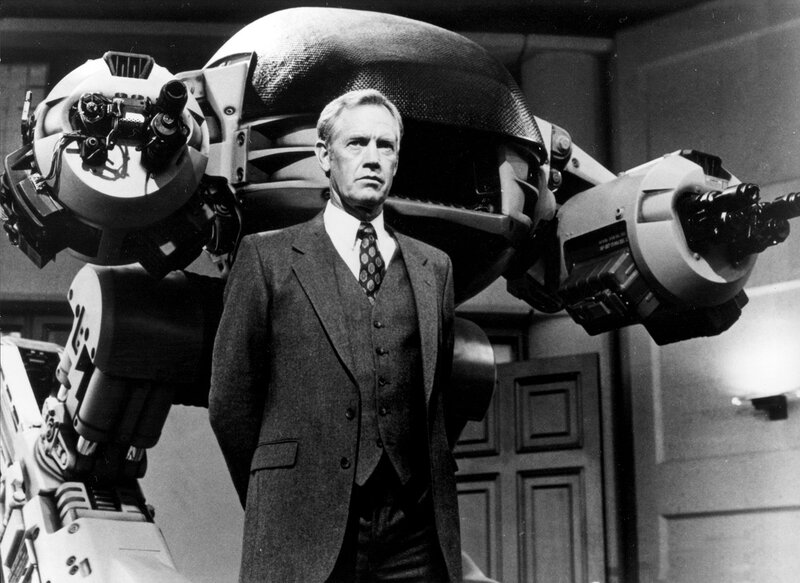 Man with robot behind him