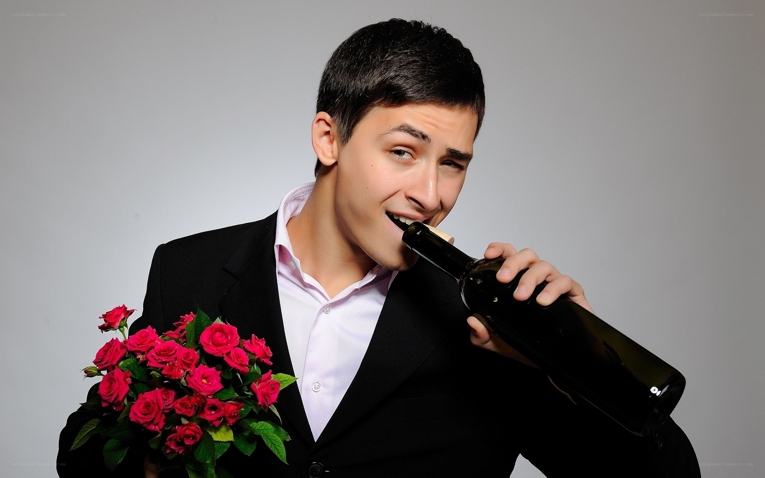 man with roses and wine bottle