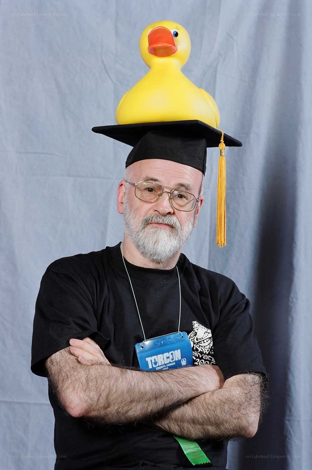 Man with rubber duck on graduation cap