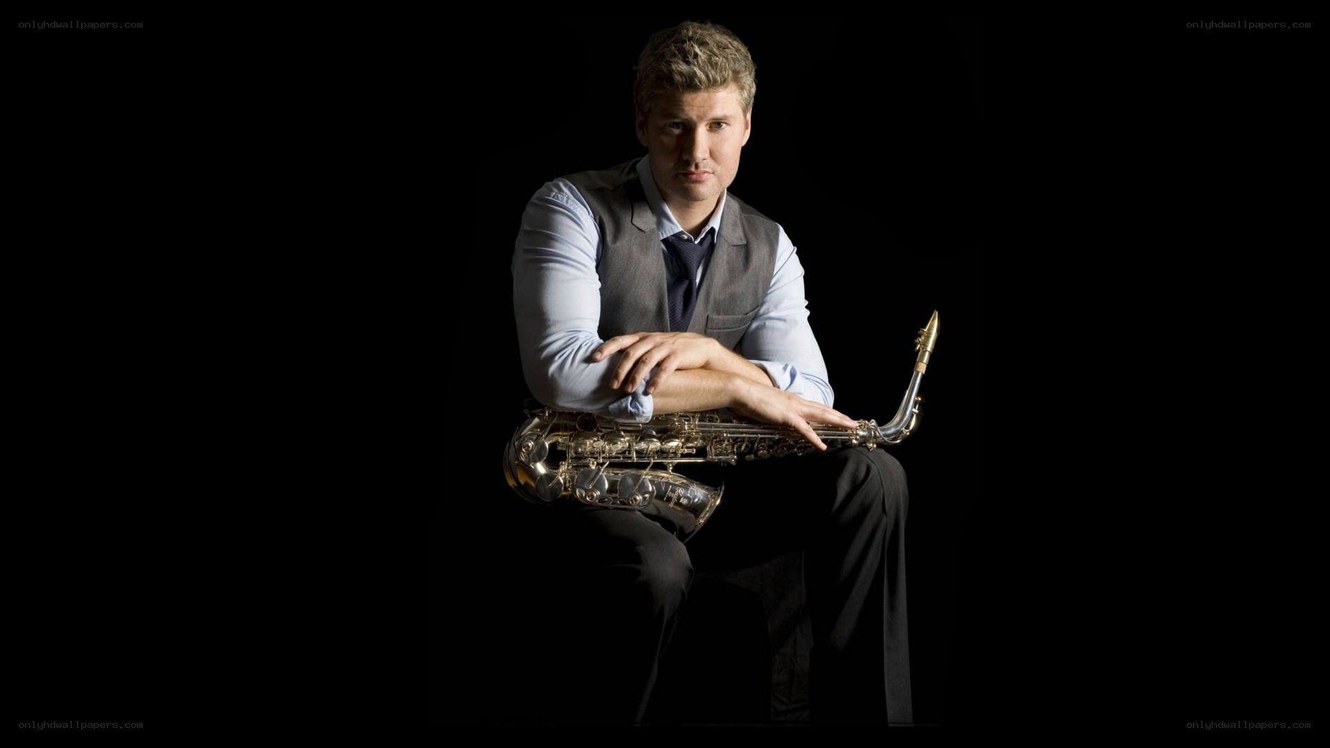 man with saxophone on black