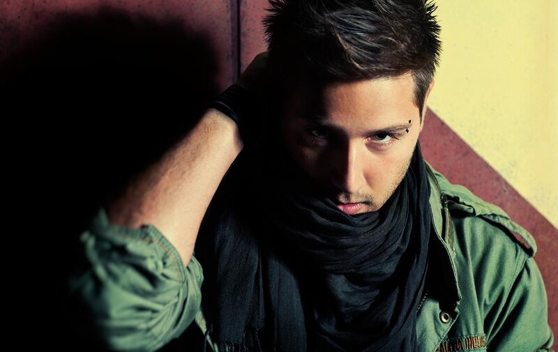 man with scarf and eyebrow piercing