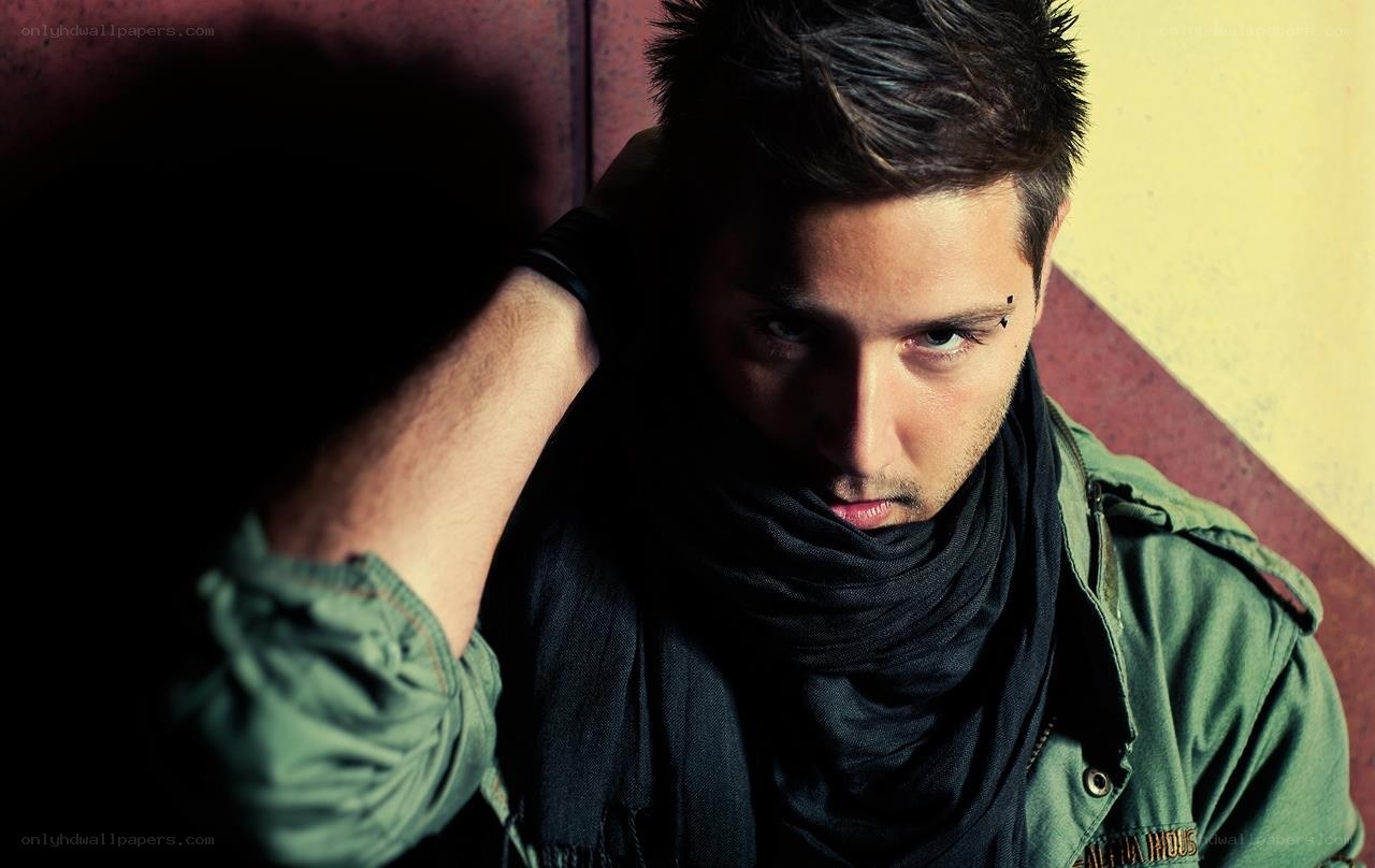 man with scarf and eyebrow piercing