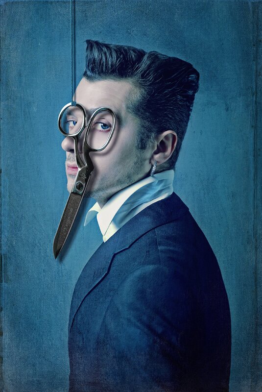man with scissors in face