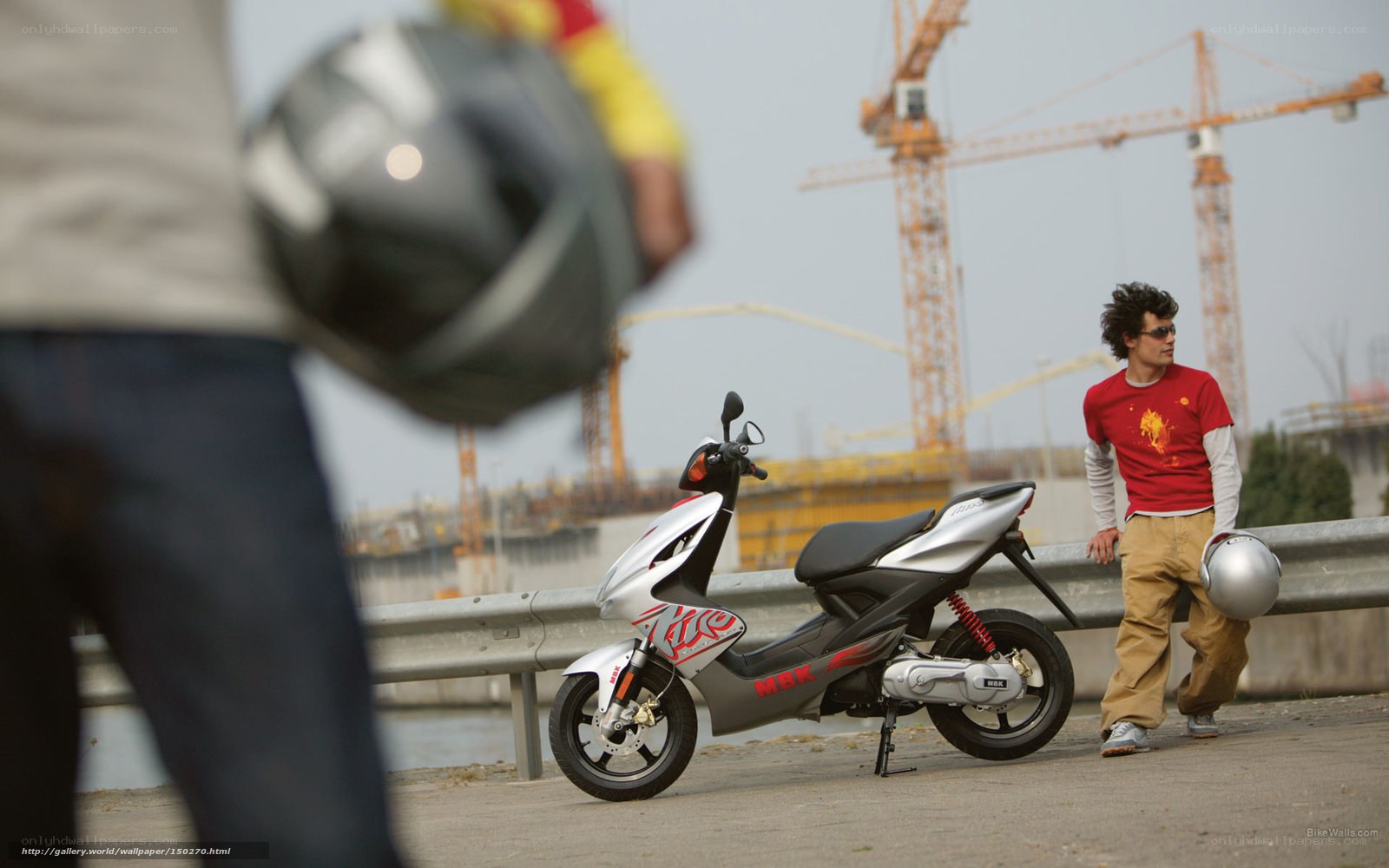 Man with scooter at construction site