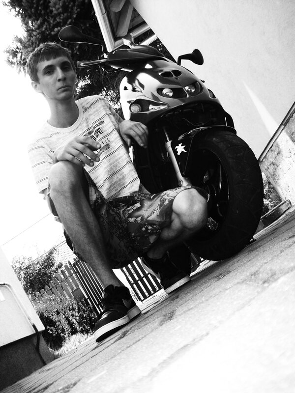 man with scooter in black and white