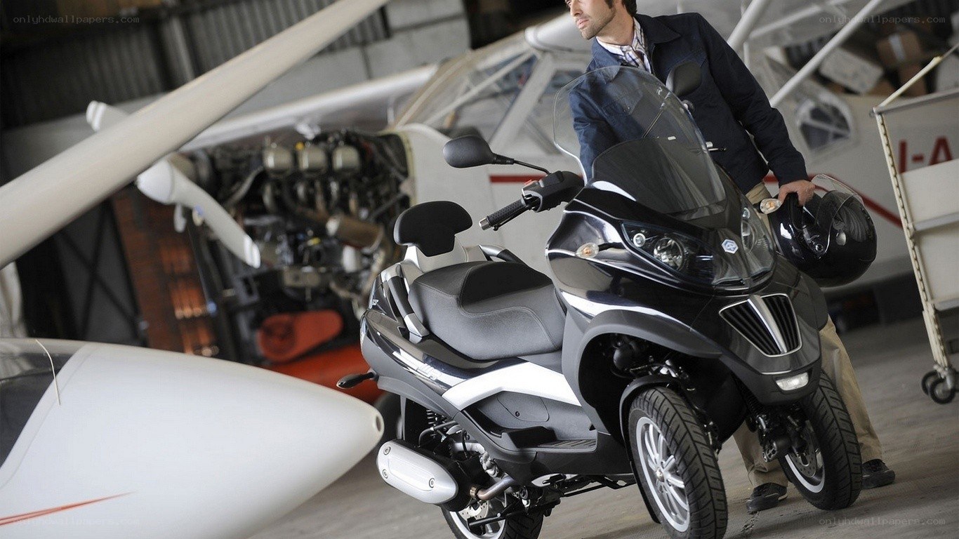 Man with scooter in hangar