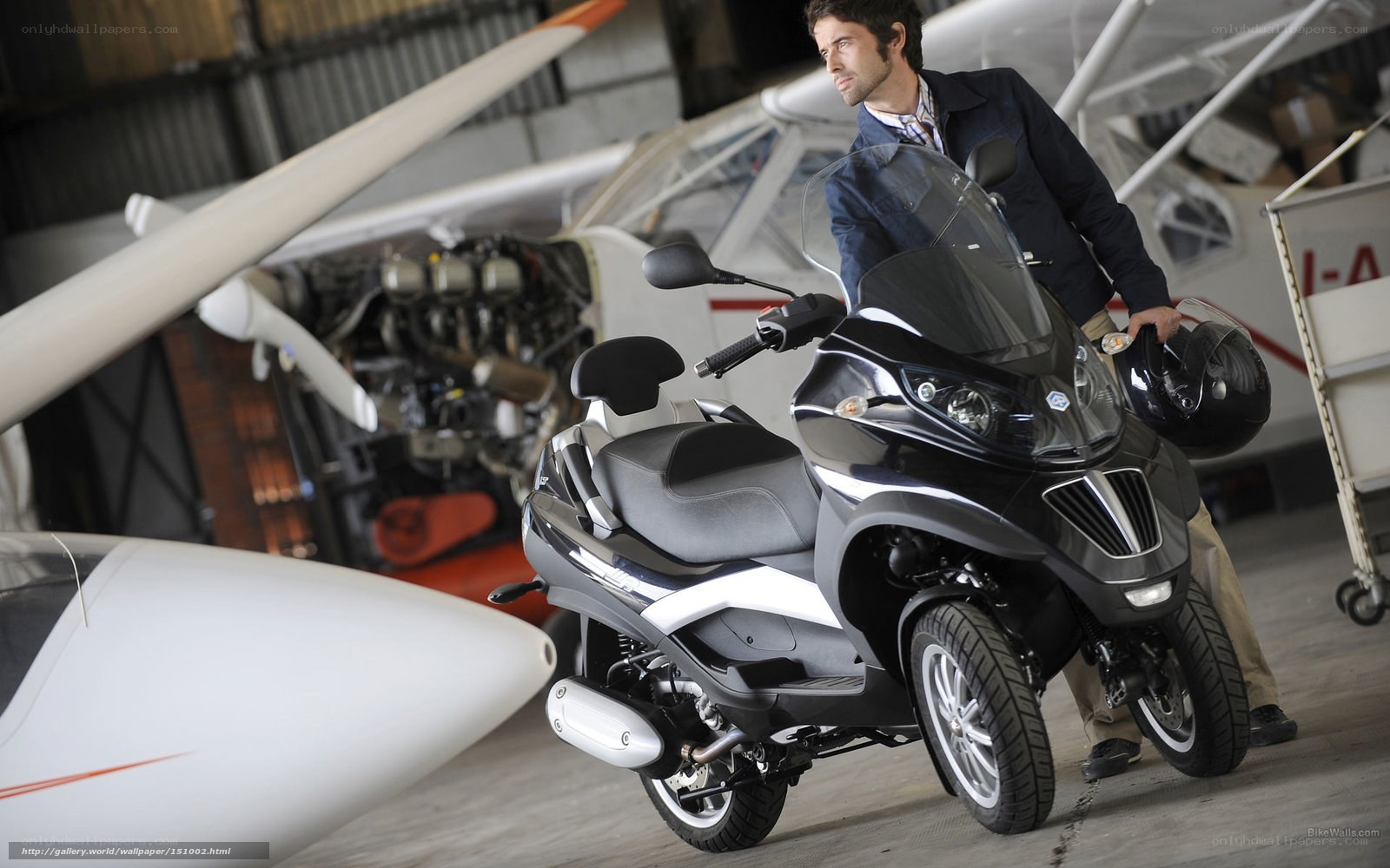 Man with scooter in hangar
