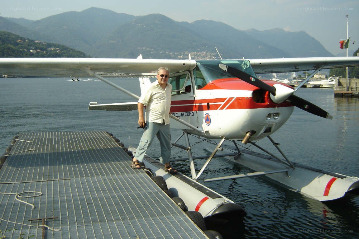 Man with seaplane on lake