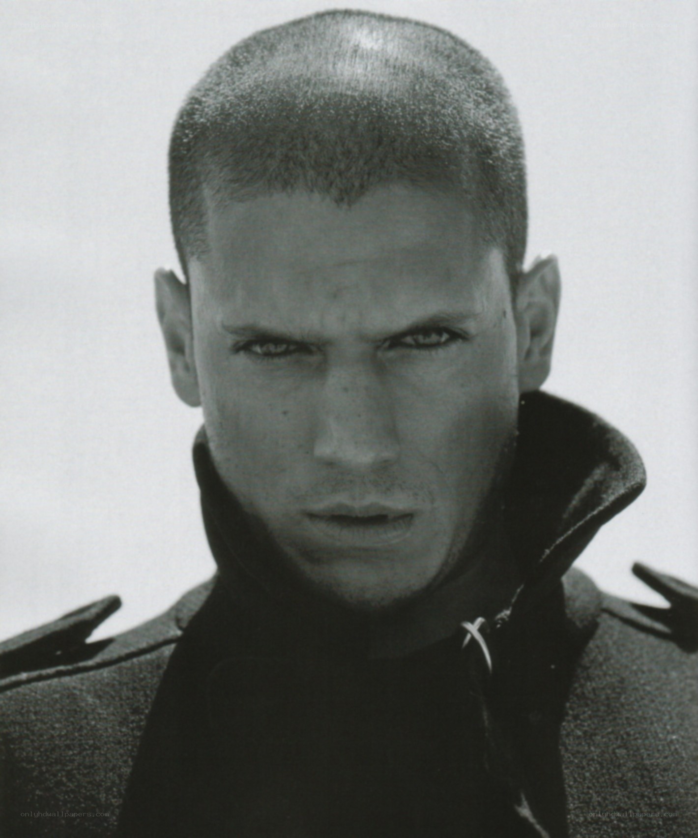 man with shaved head in coat