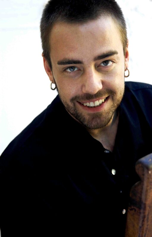 man with short hair and earrings