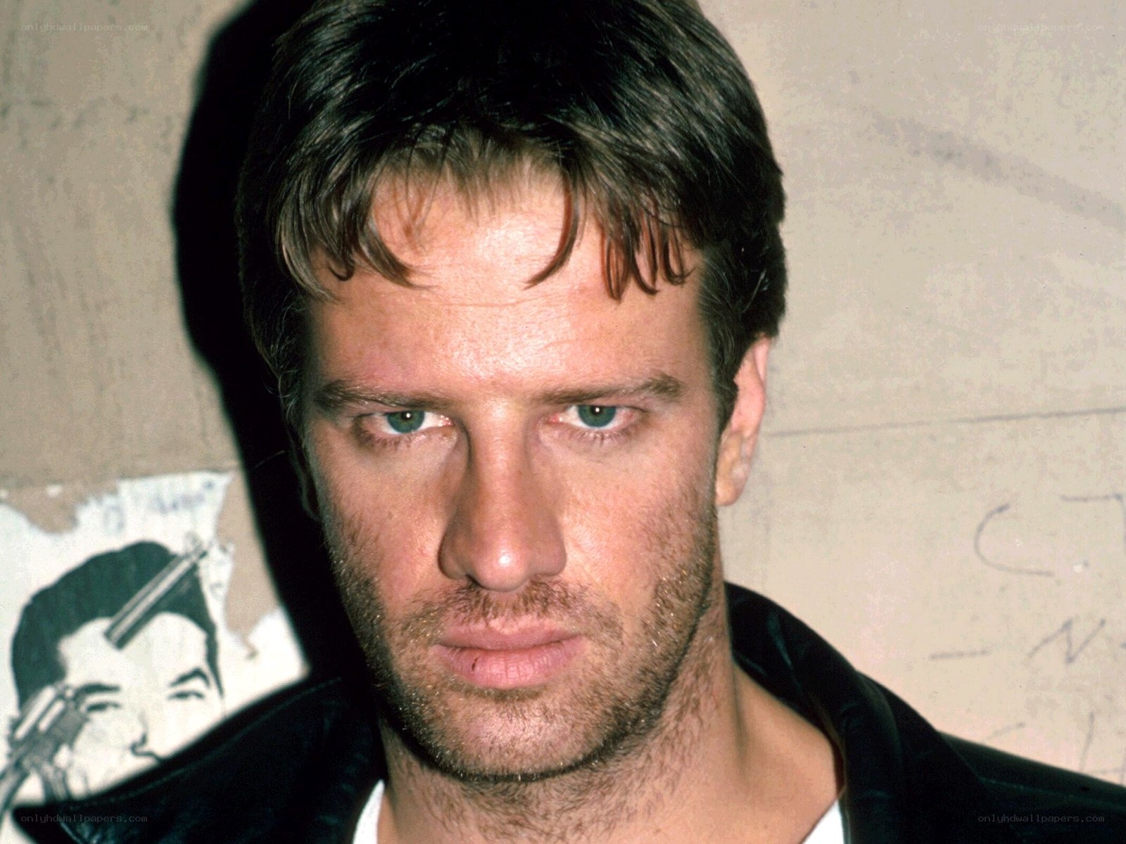 man with short hair looking at camera