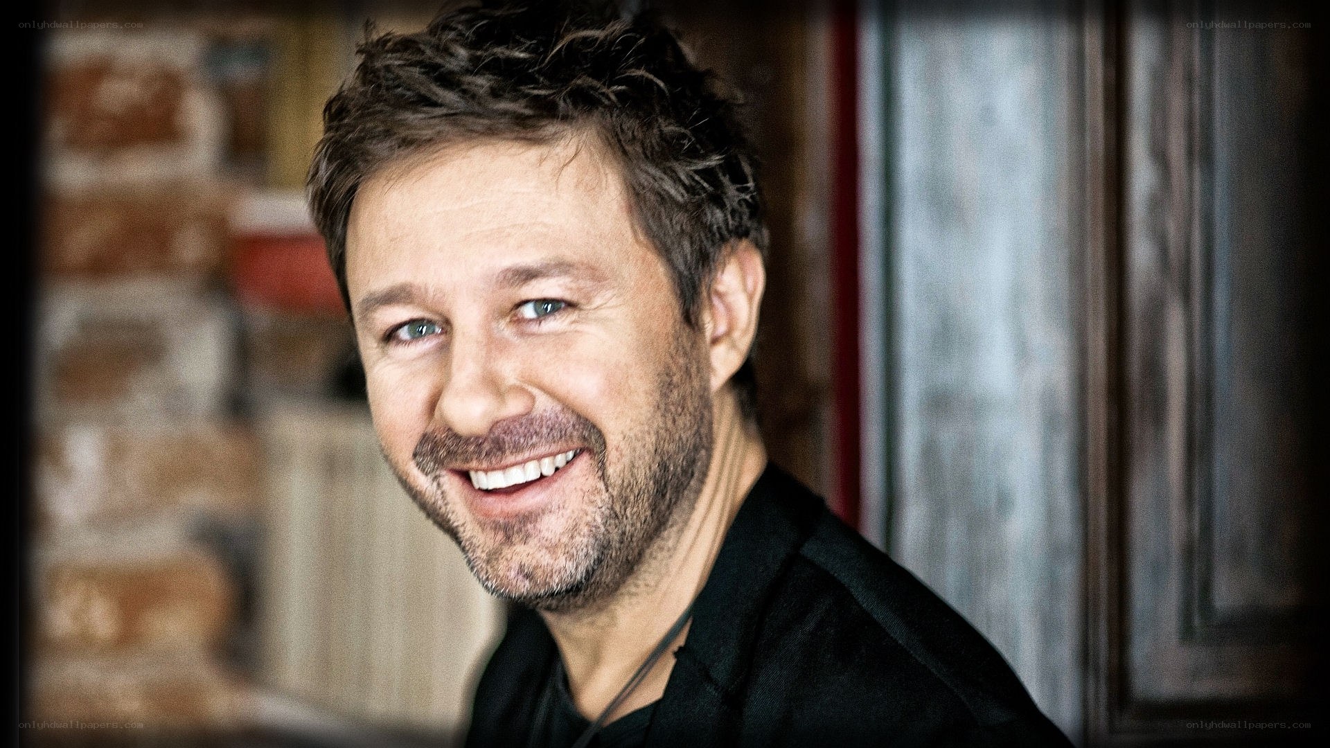 man with short hair smiling