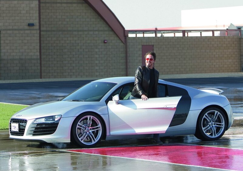 Man with silver sports car