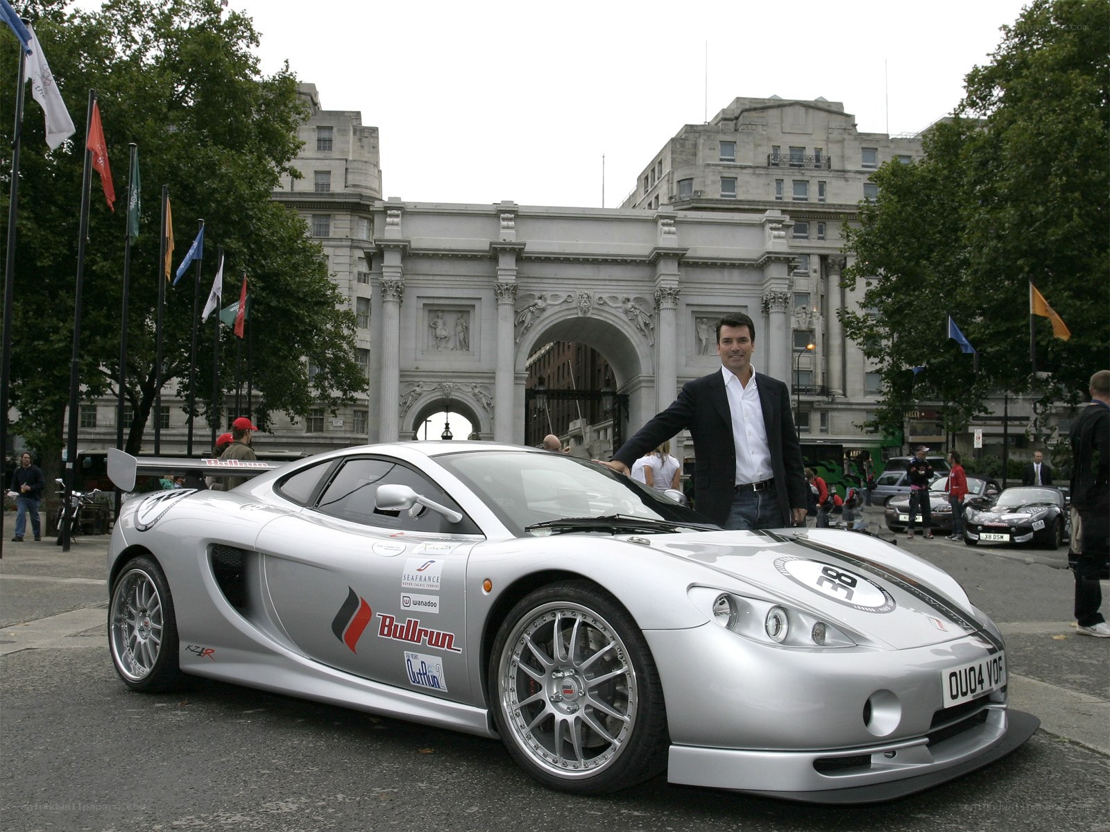 Man with silver sports car