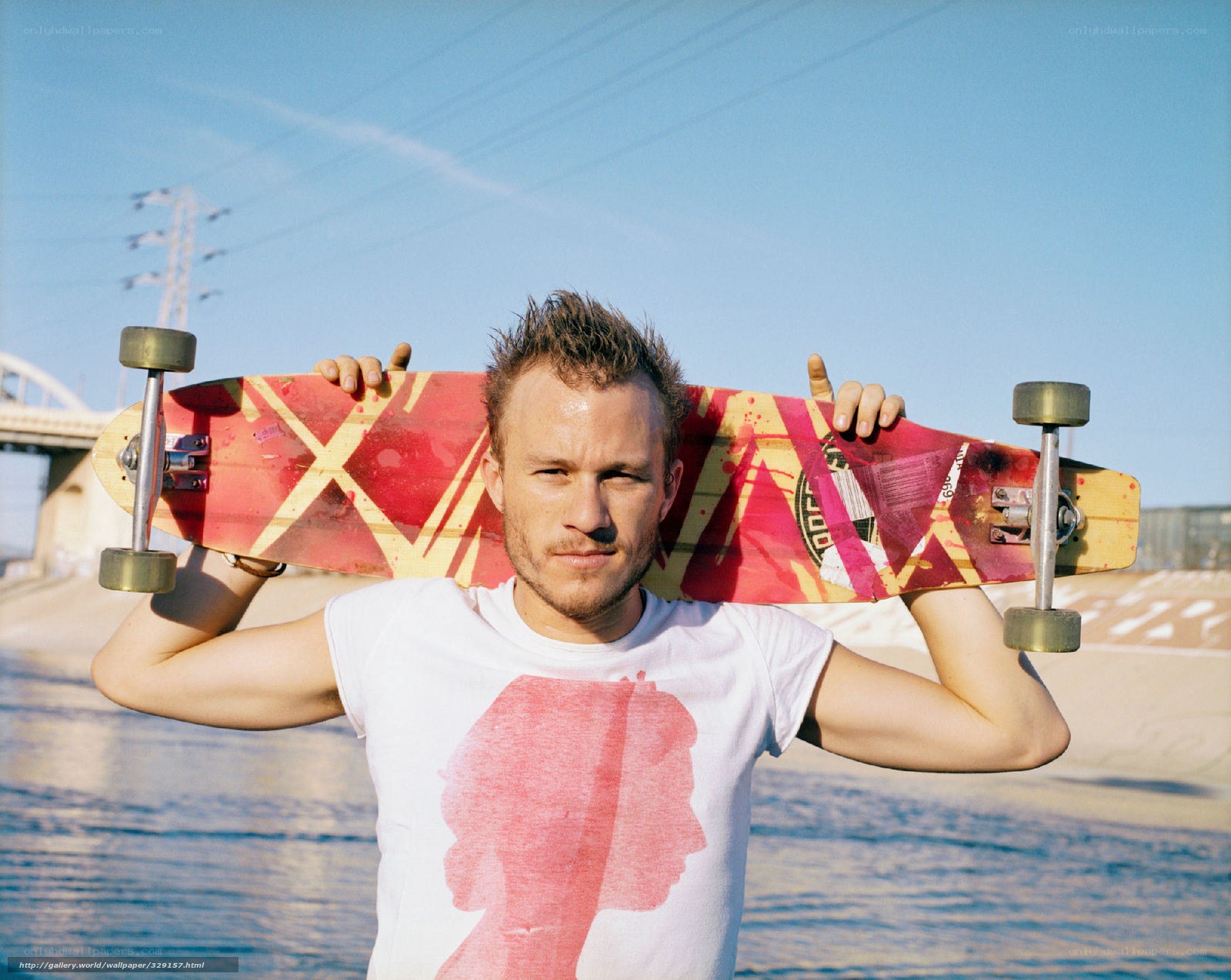 Man with skateboard on shoulder