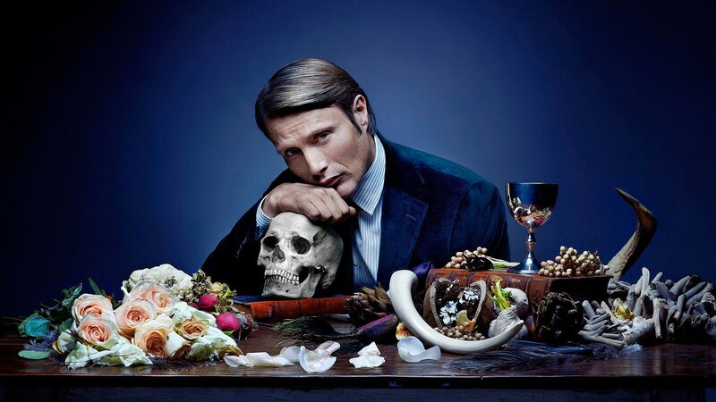 Man with skull on table