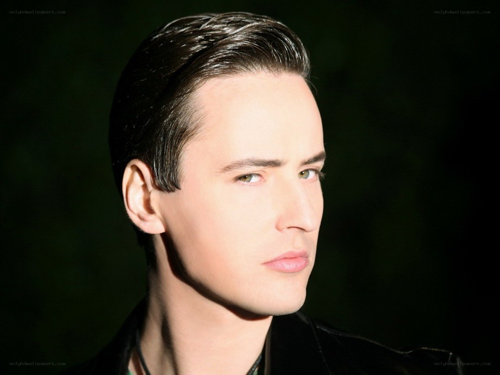 man with slicked-back hair