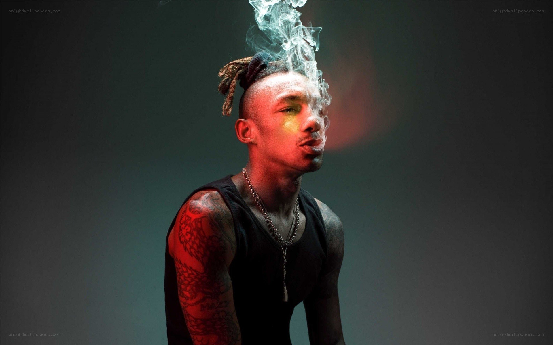 man with smoke and tattoos