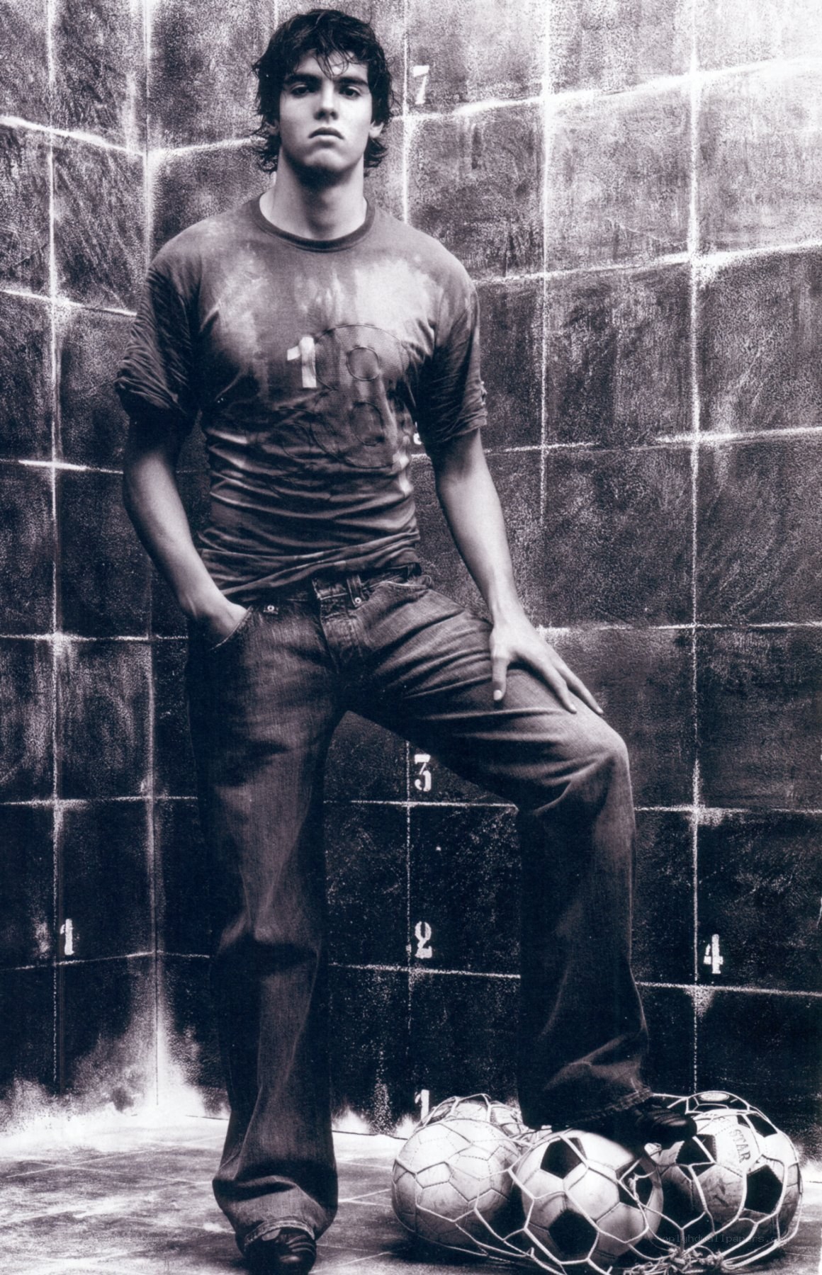 Man with soccer balls in tiled room