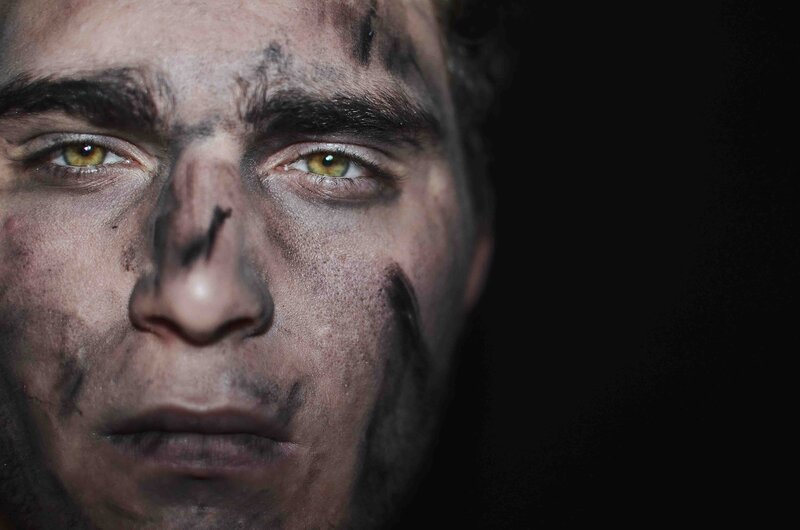 man with soot-covered face