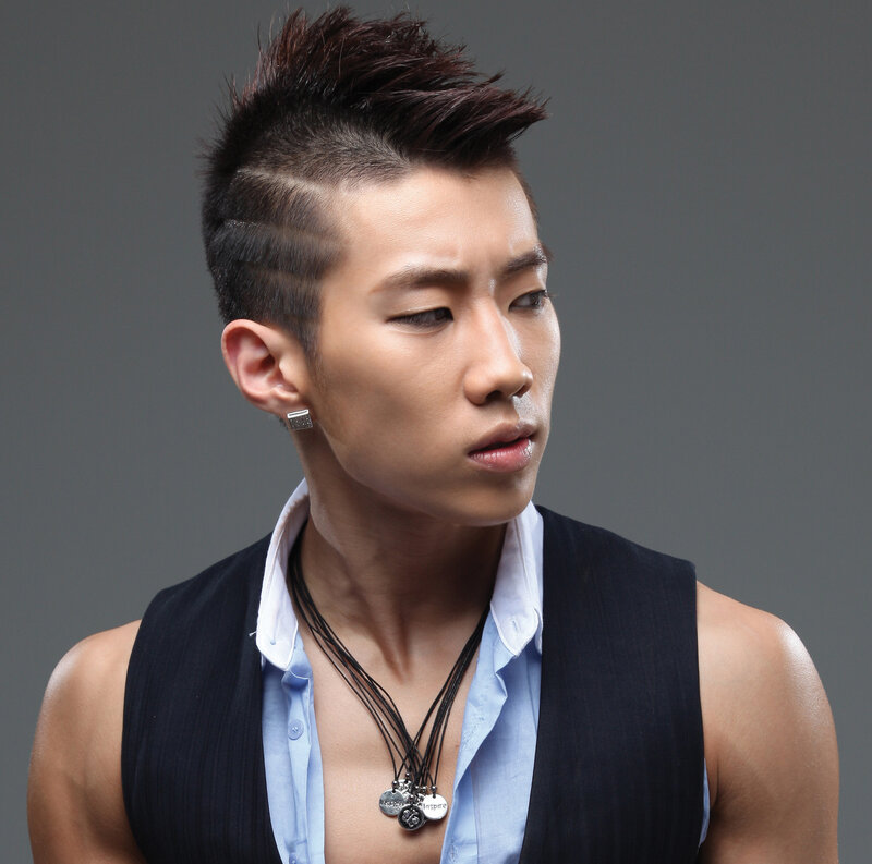 man with spiky hair and vest