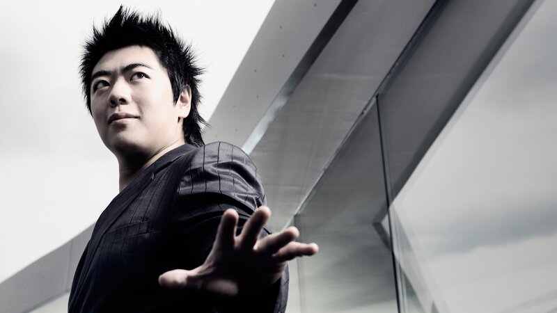 man with spiky hair in black suit