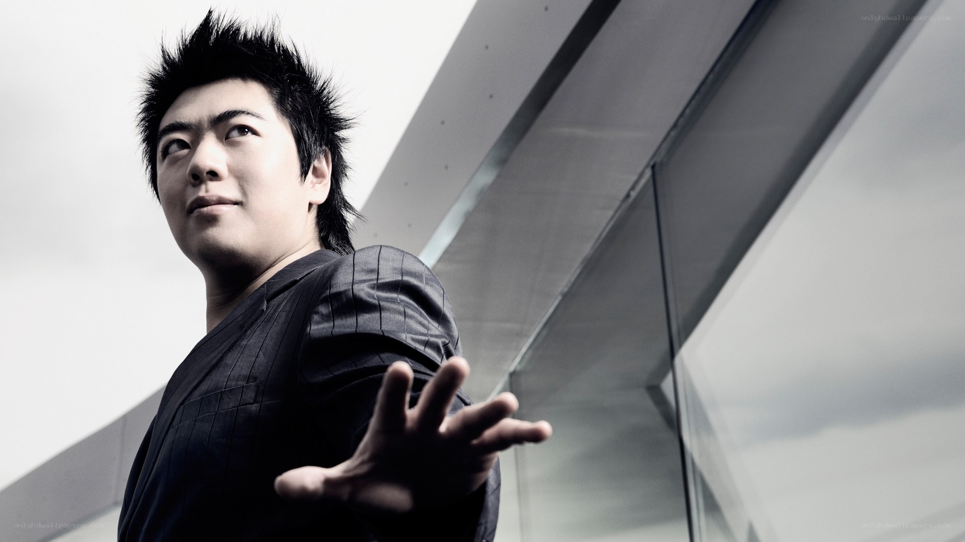 man with spiky hair in black suit