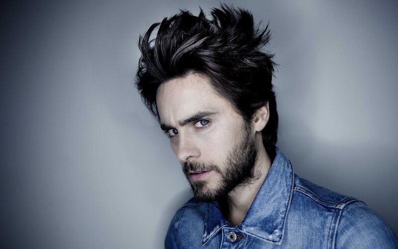 man with spiky hair in denim jacket