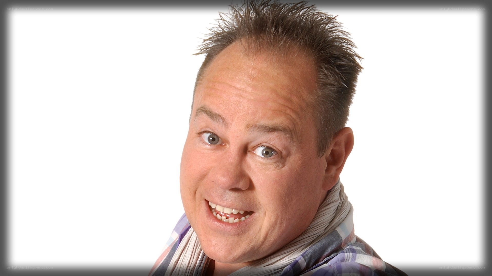 man with spiky hair smiling