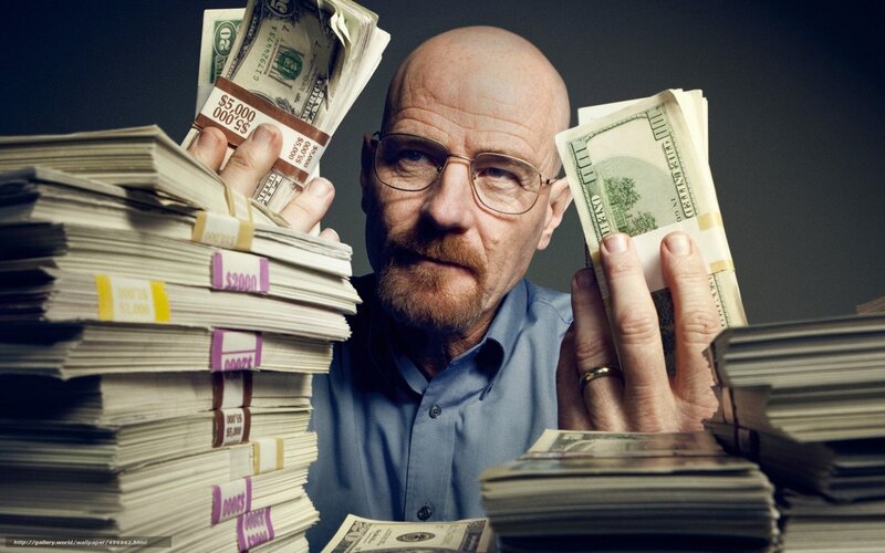 man with stacks of money